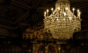 A stunning chandelier illuminates the ornate interior of a church in Porto, Portugal.